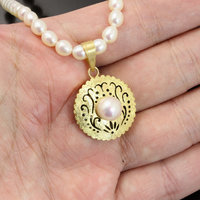 SOLD: Gold silver round pendant with a pearl necklace
