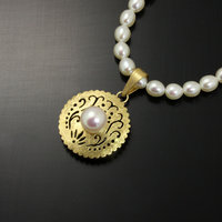 SOLD: Gold silver round pendant with a pearl necklace