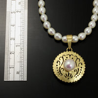 SOLD: Gold silver round pendant with a pearl necklace
