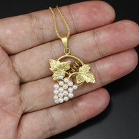 Yellow gold grape motif pendant with freshwater pearls