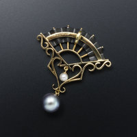 Gold and oxidized silver fan pendant with black and white pearls