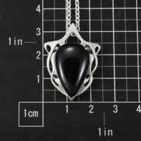 This Art Nouveau style pendant necklace is made of a black tourmaline cab and st
