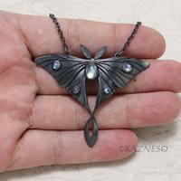 (C) KAZNESQ: Moon moth motif oxidized silver and Royal blue moonstone pendant