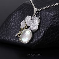 Mystical Brilliance! Silver Leaf Pendant with Rutilated Quartz Backed by Mother of Pearl