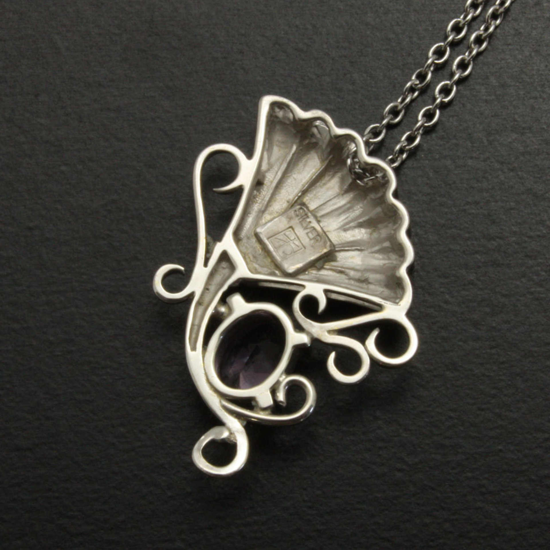 Sold: Purple spinel featured silver pendant of an imaginary flower