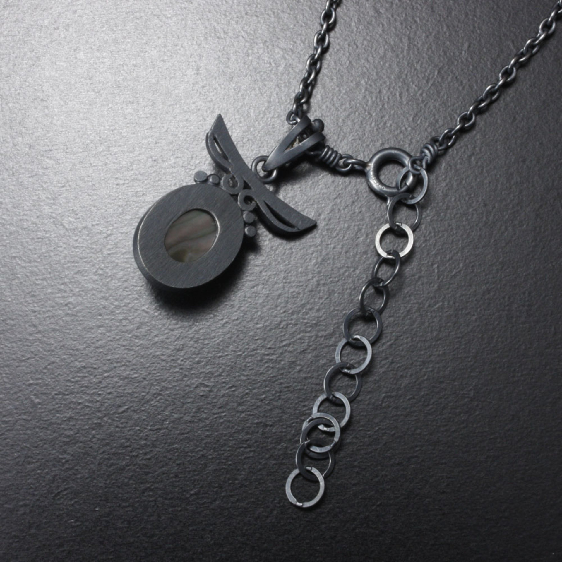 Sold: Silver pendant of quartz backed up by black pearl oyster