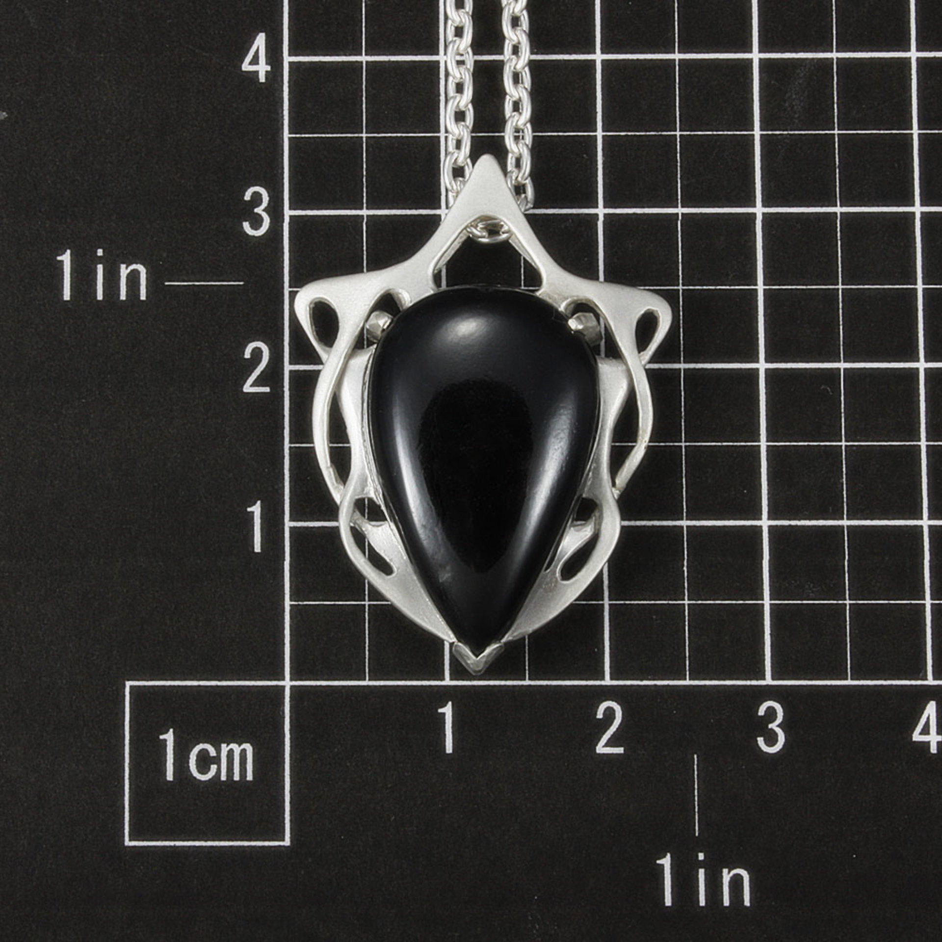 This Art Nouveau style pendant necklace is made of a black tourmaline cab and st