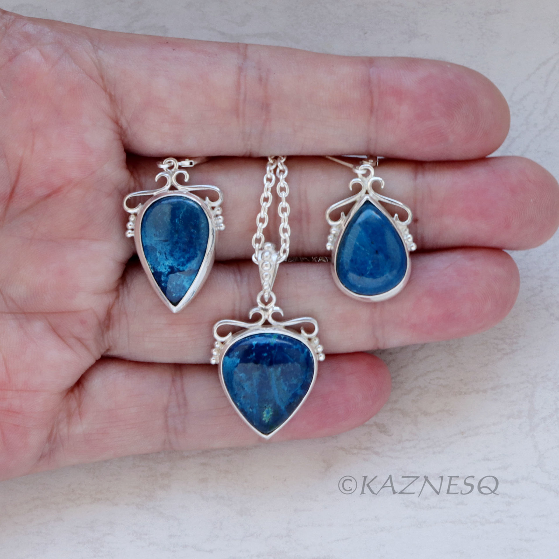 A set of Shattuckite Silver Earrings and a Necklace.