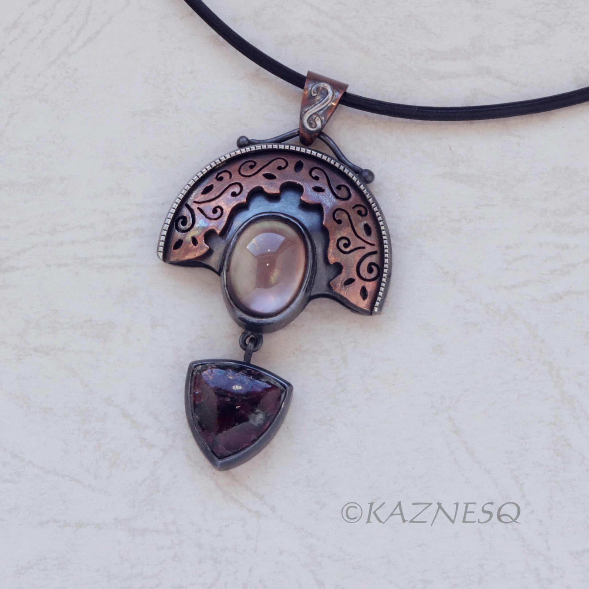 Quartz lined with Black Mother of Pearl Openwork Copper and oxidized silver Arch pendant featuring Eudialyte