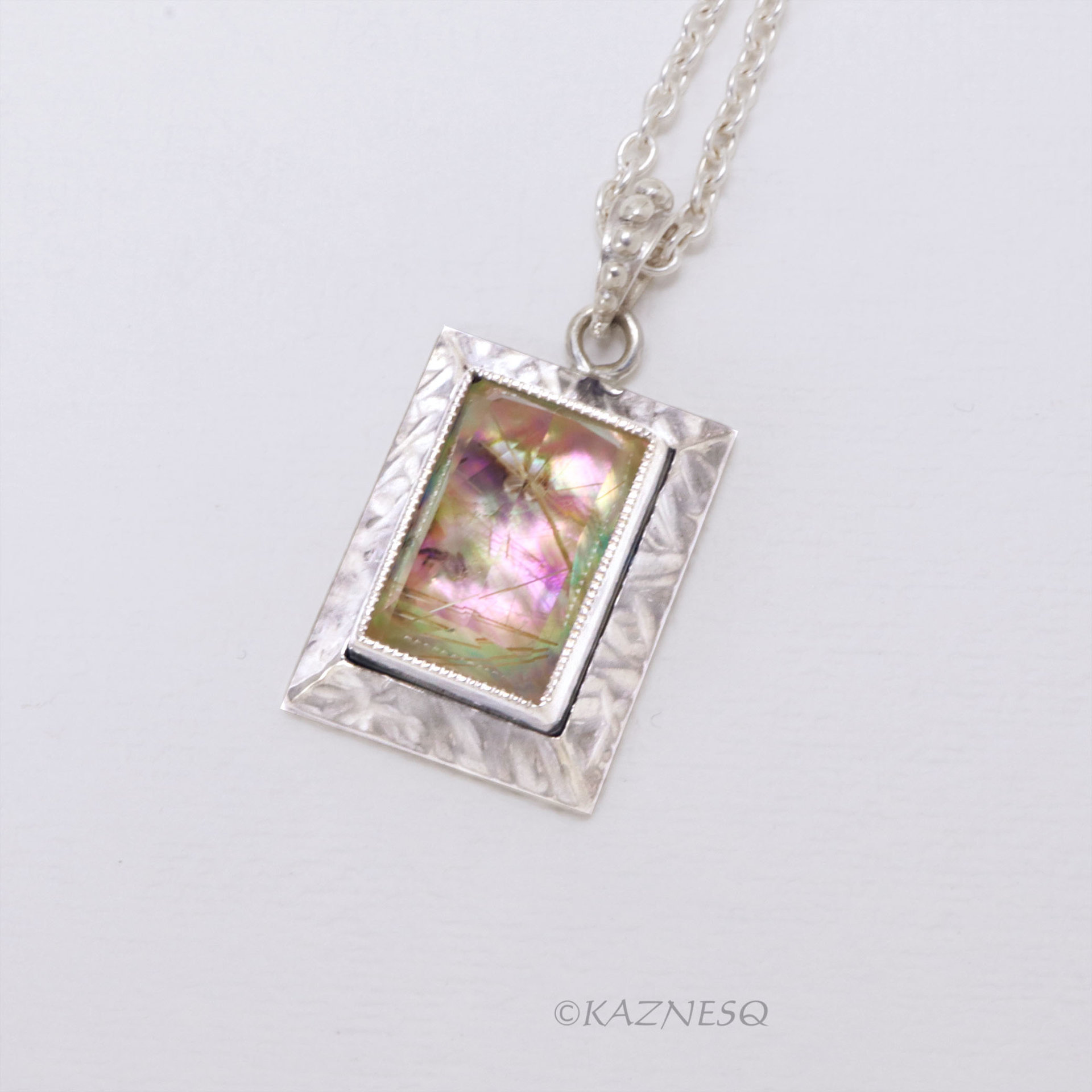 Alluring iridescence! : Rutilated Quartz with Paua Shell Rectangle Silver Pendant