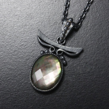 Sold: Silver pendant of quartz backed up by black pearl oyster